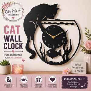 May include: Black cat wall clock with a fishbowl design. The clock features a black cat silhouette reaching towards a clock face with gold hands. The text "CAT WALL CLOCK" is displayed. The clock is aquarium-inspired and handmade.