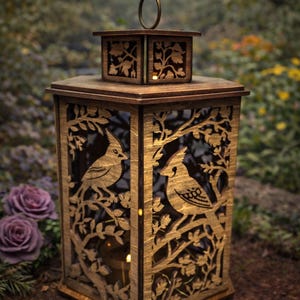 May include: Wooden bird lantern with intricate cut-out designs. Features a square shape with a handle on top. The sides showcase bird and branch silhouettes. The text "Bird Lantern" is at the top.