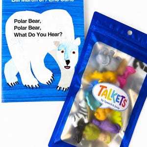 May include: A copy of the book Polar Bear, Polar Bear, What Do You Hear? by Bill Martin Jr and Eric Carle, alongside a blue resealable pouch containing various small, colorful animal-shaped figures with a Talkets by Speech & Smile label.