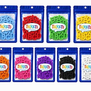 May include: Nine blue resealable pouches containing sets of plastic alphabet letters in light blue, red, green, yellow, orange, pink, purple, black, and white. Each pouch features a white label with the text TALKETS by Speech & Smile.