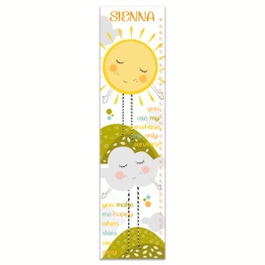 May include: A white growth chart with a yellow sun and a gray cloud with a personalized name "SIENNA". The sun and cloud have faces and are holding hands. The text reads "you are my sunshine my only sunshine you make me happy when skies are gray".
