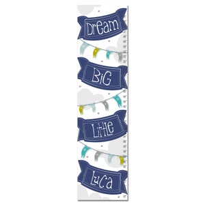 May include: A blue and white growth chart with the words "Dream Big Little Luca" on it. The chart features a string of colorful flags and stars.