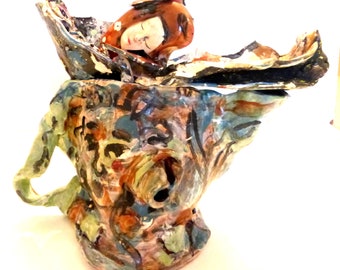 ceramic art sculpture abstract form with faces blue and brown