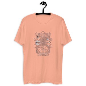 May include: A peach-colored t-shirt with a graphic print of a detailed, intricate design featuring a circular pattern with gears and other mechanical elements. The design is in shades of gray and includes the text "ONE REVOLUTION".