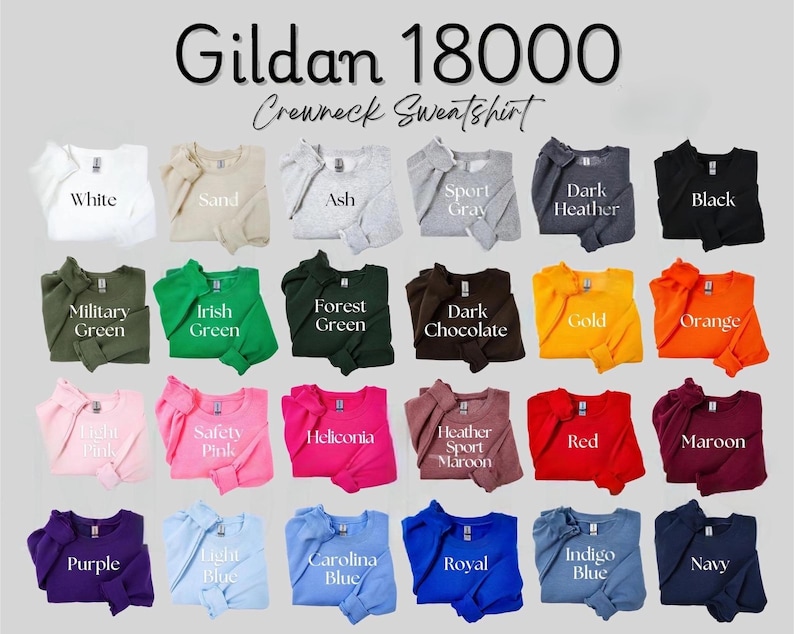 Pu&ograve; includere: Una vetrina di felpe girocollo Gildan 18000 in vari colori, tra cui bianco, nero e blu navy. L'immagine mostra una gamma di tonalit&agrave;, dal rosa chiaro al cioccolato fondente, con il nome di ogni colore visualizzato sotto.