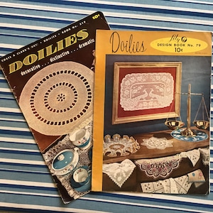 May include: Two vintage doily design books with the titles "Doilies" and "Lily Doilies Design Book No. 79 10¢". The books feature images of crocheted doilies and lace.