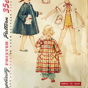 May include: Vintage Simplicity sewing pattern number 4503, size 5, for a child's dress. The pattern includes three different styles: a plaid dress with long sleeves, a white dress with short sleeves and a ruffled collar, and a blue dress with long sleeves. The pattern is printed on a white background with black text.