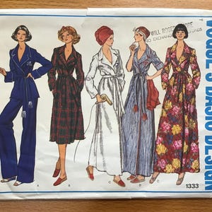 May include: Vintage Vogue's Basic Design sewing pattern 1333 showing illustrations of women's robes and pyjamas. The patterns include a navy blue pyjama set, a plaid robe, a white robe, a striped robe, and a floral robe. The pattern envelope is white and blue.