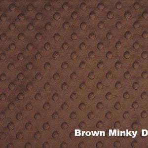May include: Brown Minky Dot fabric with a soft, textured surface. The fabric features a repeating pattern of raised dots, creating a plush, tactile feel. The text "Brown Minky Dot" is displayed in white at the bottom of the image.