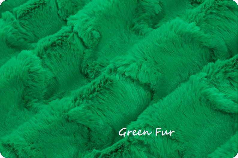 May include: A vibrant green faux fur fabric with a dense, soft texture and a repeating wavy pattern. The material features a plush, thick pile that creates deep shadows and highlights across the surface. The text Green Fur is visible.