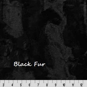 May include: Close-up of black fur fabric with a textured surface. The words "Black Fur" are written in white script. A ruler is at the bottom, marked in inches.