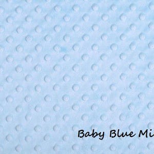 May include: A light blue minky fabric featuring a raised, embossed dot pattern across the entire surface. The fabric has a soft, textured appearance with small, uniform circular bumps. The text Baby Blue Minky is printed in black in the corner.