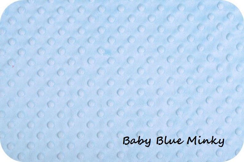 May include: A light blue minky fabric featuring a raised, embossed dot pattern across the entire surface. The fabric has a soft, textured appearance with small, uniform circular bumps. The text Baby Blue Minky is printed in black in the corner.