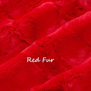 May include: Close-up of vibrant red fur fabric. The plush material has a soft, textured appearance with visible fibers. The words "Red Fur" are written in white script across the image.