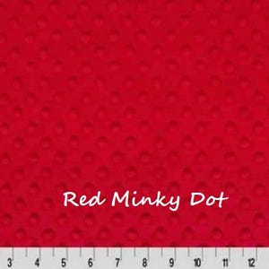 May include: Bright red minky dot fabric with a textured surface. The fabric has a dotted pattern and the text "Red Minky Dot" is displayed in white. A ruler is at the bottom of the image.