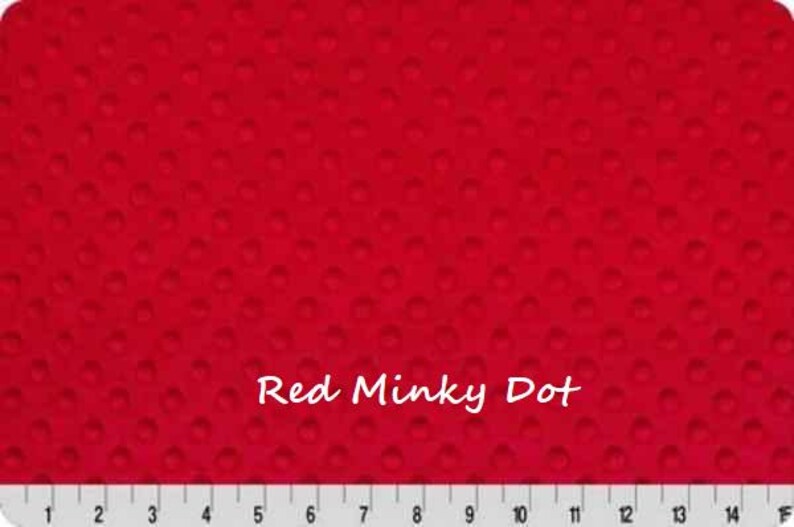 May include: Bright red minky dot fabric with a textured surface. The fabric has a dotted pattern and the text "Red Minky Dot" is displayed in white. A ruler is at the bottom of the image.