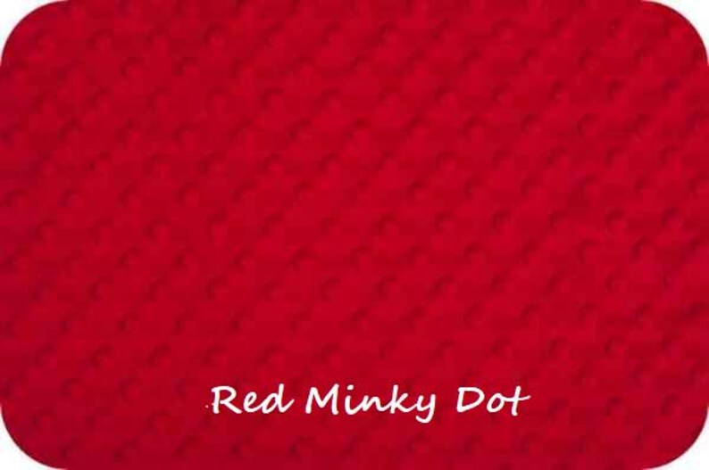 May include: Red minky dot fabric with a subtle textured pattern. The fabric is a solid red colour with a small white dot pattern.
