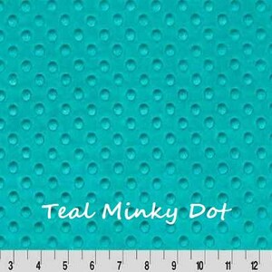May include: Teal Minky Dot fabric with a raised dot pattern. The fabric is a vibrant teal color and features a repeating pattern of small, evenly spaced dots. A ruler is at the bottom, with measurements in inches.