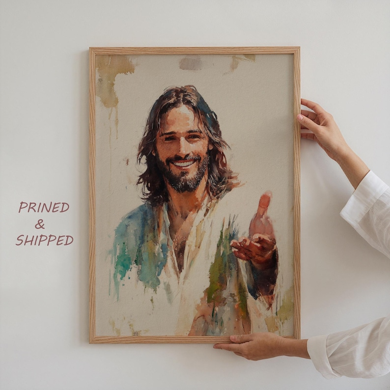 May include: A framed watercolor print of a smiling man with long brown hair and a beard, reaching out his hand. The artwork features soft blues, greens, and browns. The text "PRINTED & SHIPPED" is visible on the left side of the frame.