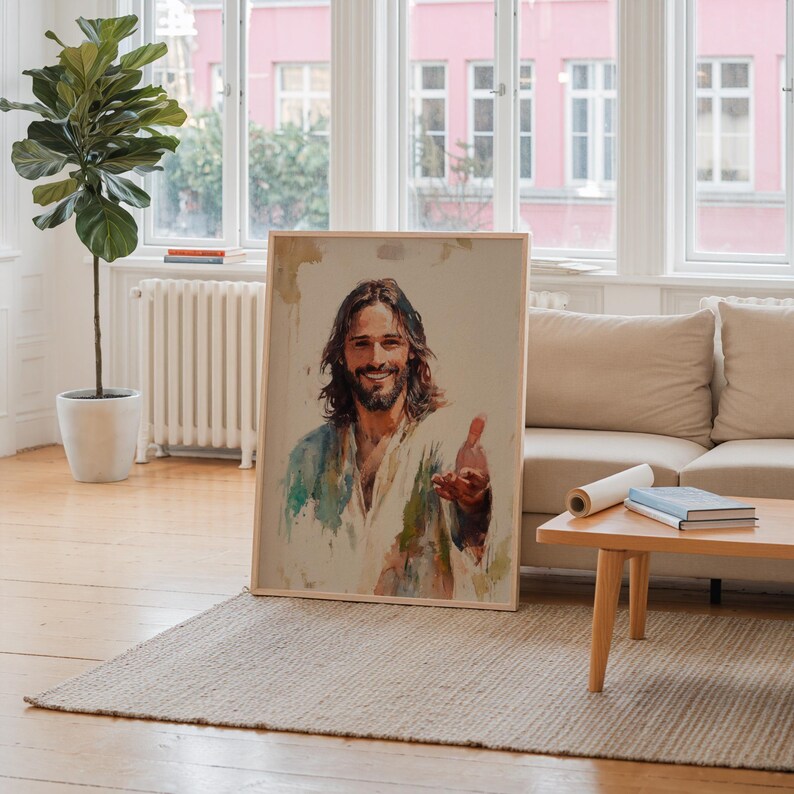 May include: A framed portrait of a man with long brown hair and a beard, wearing a white and blue robe. The painting has a watercolor style and is leaning against a wall in a well-lit room.