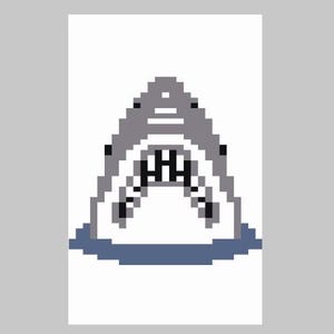 May include: Pixelated illustration of a shark's open mouth, with visible rows of teeth. The design uses a grey and white colour scheme with a blue base, creating a retro, digital art aesthetic. The shark's mouth is the focal point of the image.