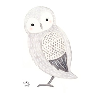 A cute snow owl with soft gray and white is looking at the viewer.  It has very lightly blushed pink cheeks.