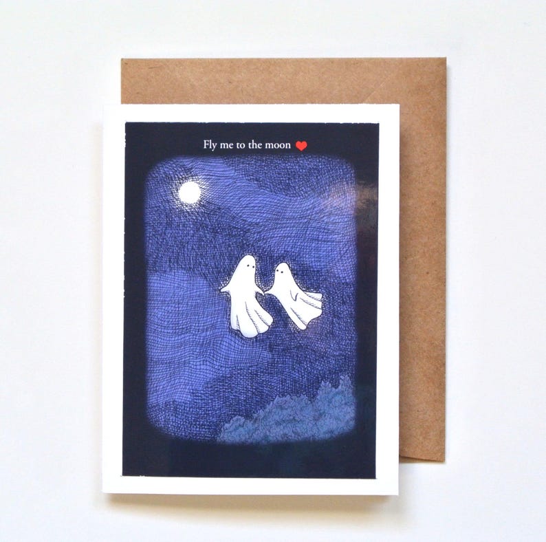 Two ghosts are flying in the night sky with a full moon.  The card says; Fly me to the moon