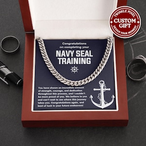 May include: A silver chain necklace in a red gift box. The navy blue card inside reads "Congratulations on completing your NAVY SEAL TRAINING" with an anchor graphic. The box also has the text "Twinkle Pixel Custom Gift".