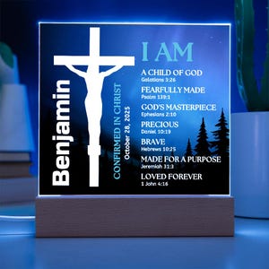 May include: A personalized night light with a wooden base. The illuminated panel features a white cross, the name "Benjamin", and inspirational text including Bible verses. The background is a dark blue with a forest silhouette.