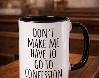 May include: White ceramic mug with a black interior and handle. The mug features the text "DON'T MAKE ME HAVE TO GO TO CONFESSION" in black, bold letters. The mug is set on a wooden surface.