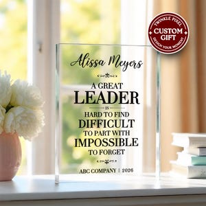 May include: A clear acrylic plaque with the text "Alissa Meyers, A Great Leader is Hard to Find, Difficult to Part With, Impossible to Forget." The plaque also includes the text "ABC Company | 2026" and a "Twinkle Pixel Custom Gift" logo.