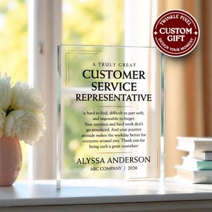 May include: A rectangular clear acrylic plaque featuring black printed text that reads A TRULY GREAT CUSTOMER SERVICE REPRESENTATIVE is hard to find, difficult to part with, and impossible to forget. ALYSSA ANDERSON ABC COMPANY 2026.