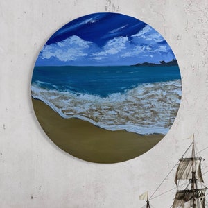 May include: Round painting depicting a beach scene. The top half shows a blue sky with white clouds. Below, the ocean meets a sandy beach. The artwork is a circle, with a diameter of approximately 12 inches.