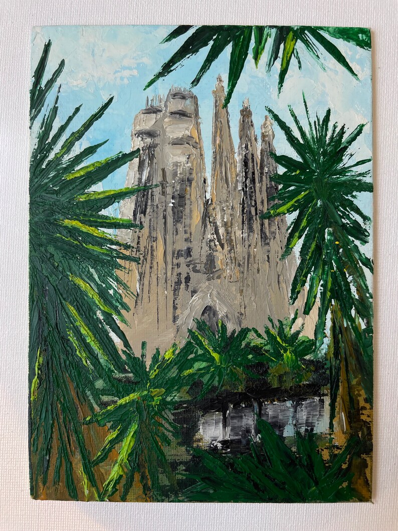 May include: An oil painting depicts a towering cathedral with intricate spires, framed by lush green palm fronds. The artwork uses a palette of beige, gray, and green, set against a light blue sky. The brushstrokes create a textured, impressionistic effect.