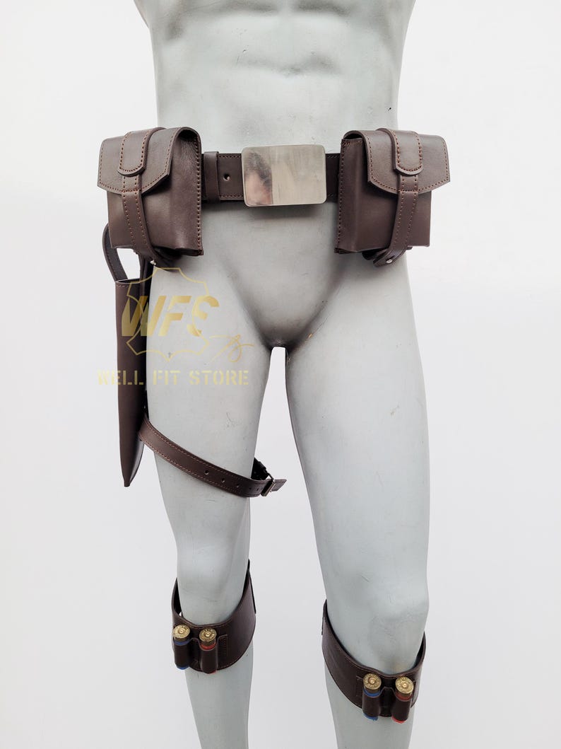 May include: Brown leather belt with multiple pouches and a silver buckle. The belt is worn on a mannequin and has a brown leather holster attached to the left leg. There are also two brown leather bands with silver buckles on the lower legs.
