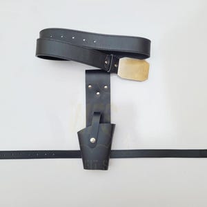 May include: A black leather belt with a gold buckle and a matching black leather holster. The holster has a small loop on the side.