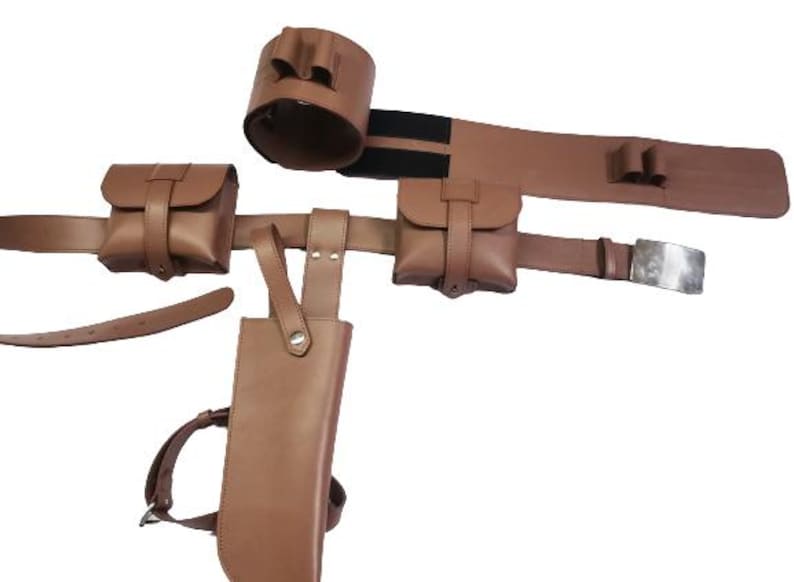 May include: Brown leather belt with multiple pouches and a holster. The belt has a silver buckle and a black elastic strap.