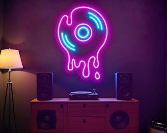 May include: A neon sign in the shape of a melting vinyl record, with a pink outline and blue accents, is mounted on a dark wall. A wooden cabinet with speakers and a record player is below. A floor lamp is to the left.
