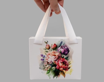 Caja de regalo de cartón con estampado floral y asas de satén.