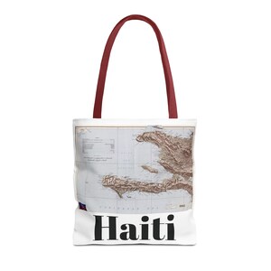 May include: White tote bag with maroon handles featuring a vintage map of Haiti with the word "Haiti" printed in black at the bottom.