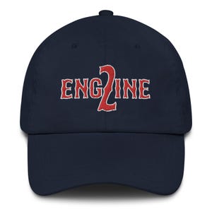 May include: A navy blue baseball cap with a red embroidered design that says "ENG2INE".