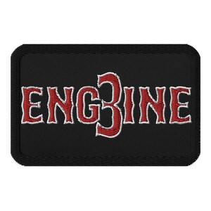 May include: Black embroidered patch with white outline. The patch says "ENG3INE" in red lettering.