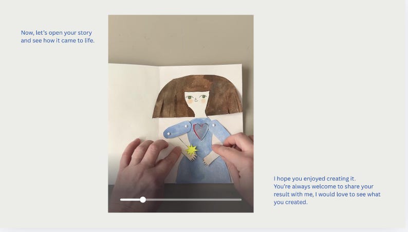 May include: A handmade paper doll with a blue dress and brown hair is displayed in an open book. The doll holds a yellow star. Text on the left reads "Now, let's open your story and see how it came to life."