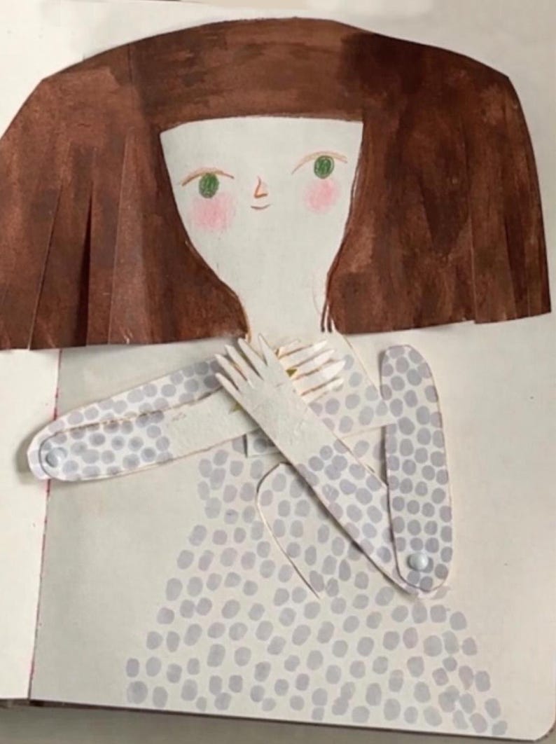 May include: Illustration of a paper doll figure with brown hair, green eyes, and rosy cheeks. The figure wears a light gray dress with a pattern of blue-gray dots. The arms are crossed, and the hands are visible.