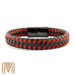 May include: A black leather bracelet with a braided design and red stitching. The bracelet has a black magnetic clasp with the text "Your Text". A fashionable accessory.