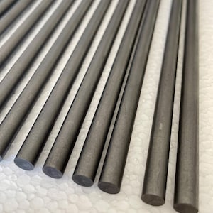 May include: A close-up of a group of 14 gray metal rods arranged in a fan shape. The rods are smooth and have a slightly textured surface.