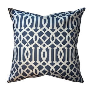 May include: Square decorative pillow with a navy blue background and a white geometric trellis pattern. The pillow has a soft, inviting appearance, suitable for adding a touch of elegance to any living space.