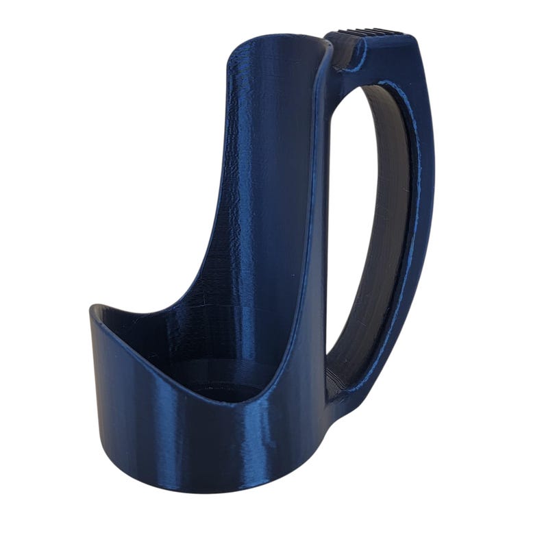 May include: A dark blue plastic cup holder with a handle. The holder is designed to hold a cup or bottle securely.