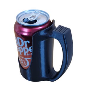 May include: A black 3D printed can holder with a handle. A can of Dr Pepper is in the holder. The can has the text "Dr Pepper Est. 1885" on it.
