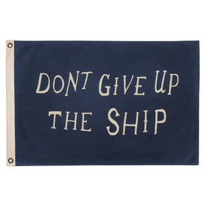 May include: A navy blue flag with white text that reads "DON'T GIVE UP THE SHIP".